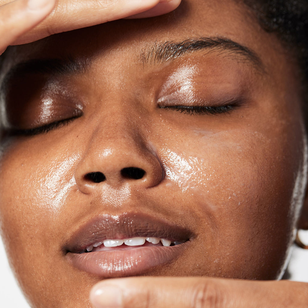 Close-up of a person applying makeup cleansing balm