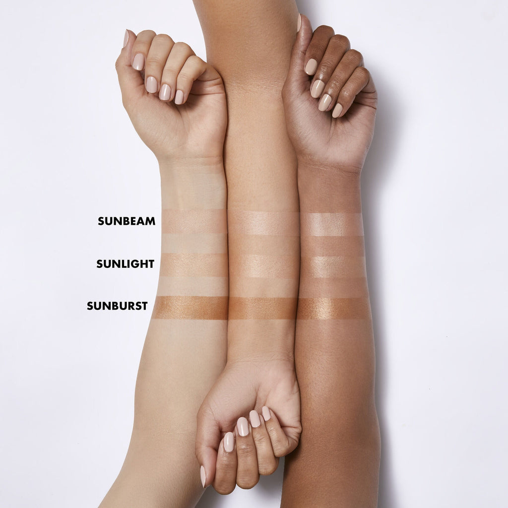 Arm swatches with different skin tones showing Suntouchable Whoa Glow SPF 30 shades: Sunbeam, Sunlight, and Sunburst.